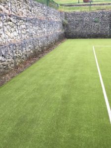 A rejuvenated synthetic tennis court after our professional maintenance services.